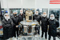 Clean-room team with Orbiter SN3 space tug and Otter Pup docking spacecraft
